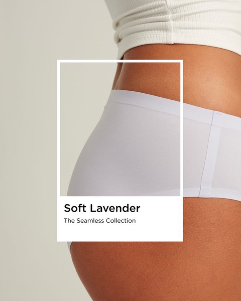 A close-up, minimalist product shot of seamless underwear in a soft lavender color, utilizing a clean frame-within-a-frame layout.